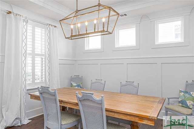 dining area with a healthy amount of sunlight and dark hardwood / wood-style flooring