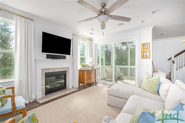 living room featuring light hardwood / wood-style floors and ceiling fan