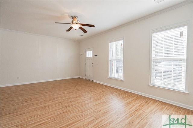 interior space with ornamental molding, plenty of natural light, ceiling fan, and light wood-type flooring