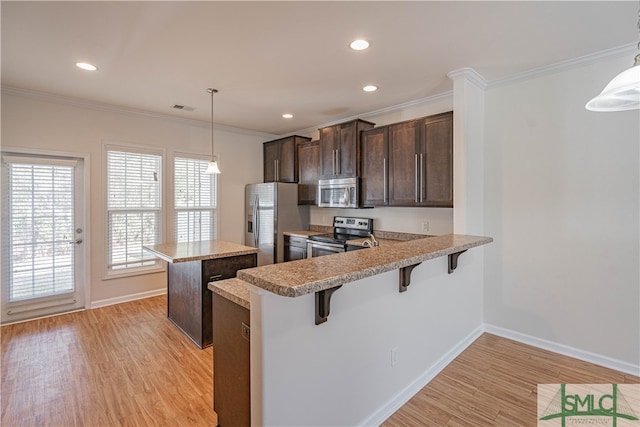 230 Ventura Pl, Pooler, GA 31322 - kitchen with pendant lighting, a breakfast bar area, stainless steel appliances, and kitchen peninsula