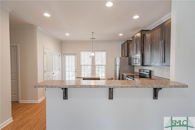 230 Ventura Pl, Pooler, GA 31322 - kitchen featuring appliances with stainless steel finishes, a kitchen breakfast bar, and kitchen peninsula