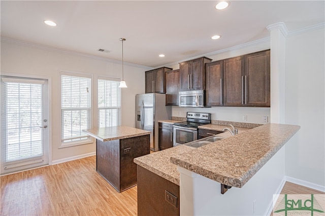 230 Ventura Pl, Pooler, GA 31322 - kitchen featuring light hardwood / wood-style flooring, a breakfast bar, appliances with stainless steel finishes, a center island, and decorative light fixtures