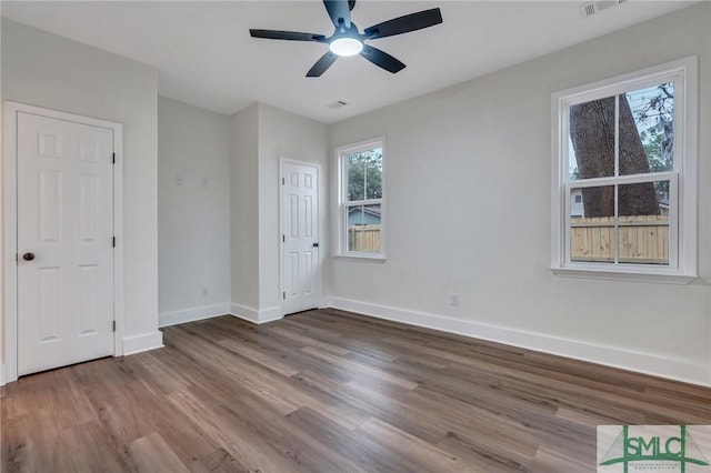 unfurnished bedroom featuring hardwood / wood-style floors and ceiling fan