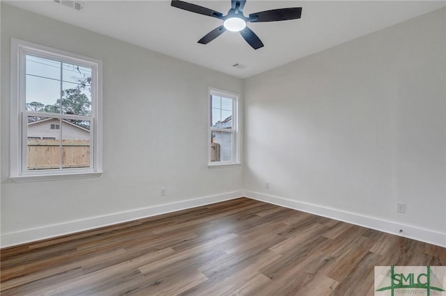 spare room featuring wood-type flooring and ceiling fan