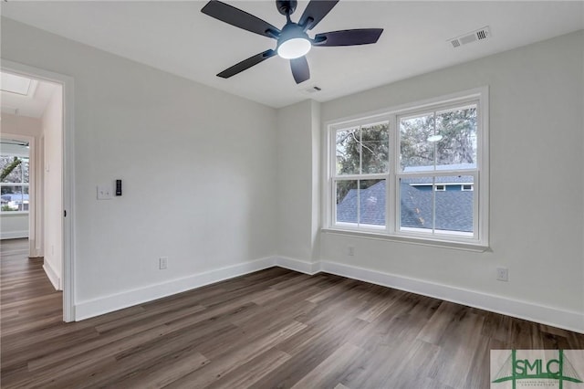 empty room with dark hardwood / wood-style flooring and ceiling fan