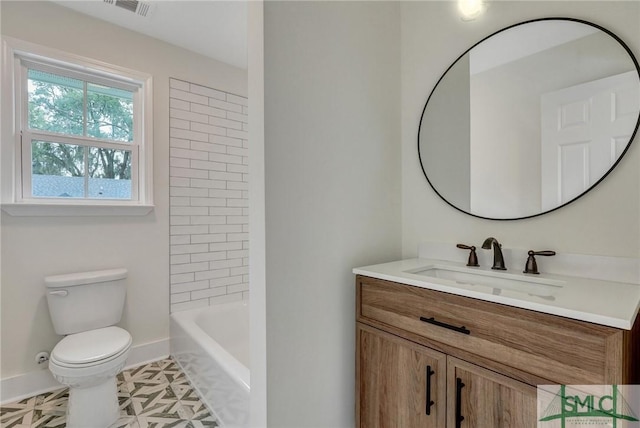 full bathroom featuring tiled shower / bath, vanity, and toilet