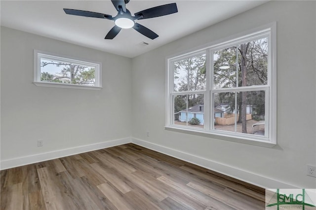 unfurnished room featuring ceiling fan and hardwood / wood-style floors