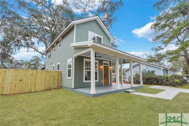 rear view of house with a yard, a patio area, and ceiling fan