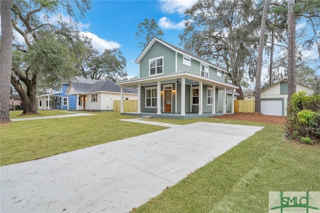 view of front of home featuring a garage, a porch, an outbuilding, and a front lawn