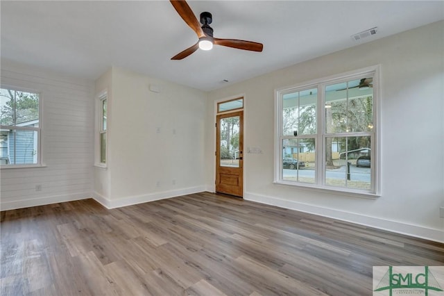 empty room with wood-type flooring and ceiling fan