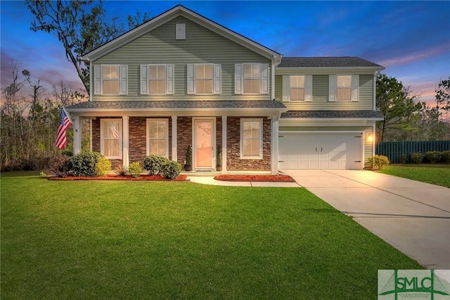 view of front of property featuring a garage and a lawn