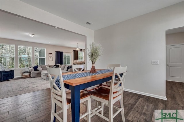 dining room with dark hardwood / wood-style floors