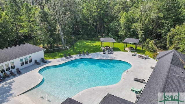 view of pool featuring a gazebo, a yard, an outbuilding, and a patio