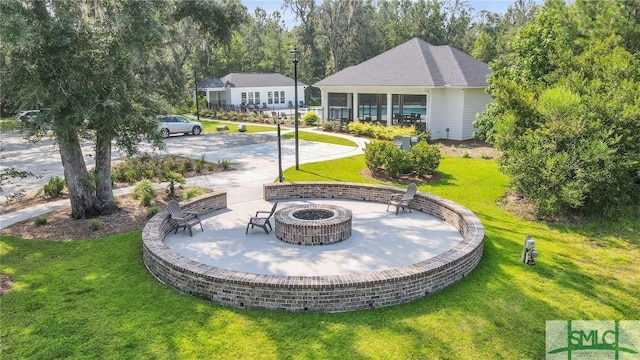 view of yard featuring an outdoor fire pit and a patio