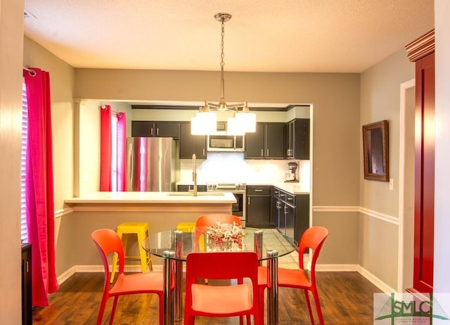 dining area featuring sink and dark hardwood / wood-style floors