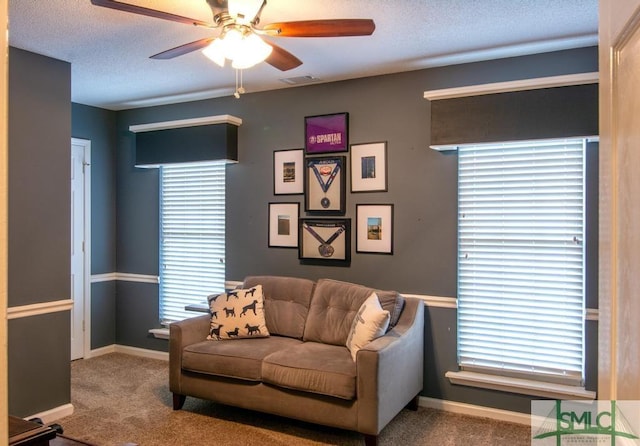 carpeted living room with ceiling fan, a textured ceiling, and a wealth of natural light