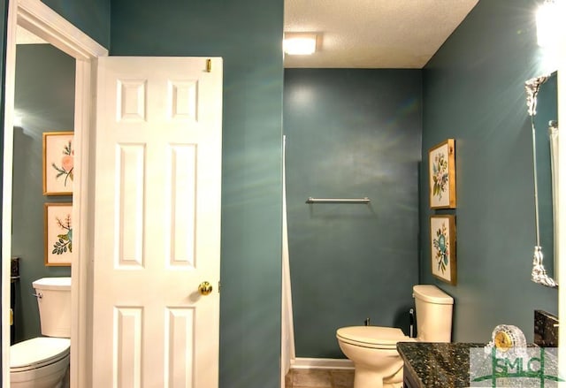 bathroom featuring a textured ceiling and toilet