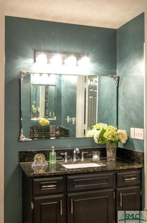 bathroom with vanity and a textured ceiling