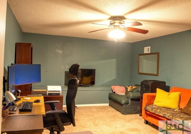 office space featuring ceiling fan, light colored carpet, and a textured ceiling