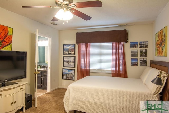 carpeted bedroom with connected bathroom, sink, and ceiling fan