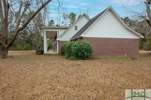 view of side of property with a yard