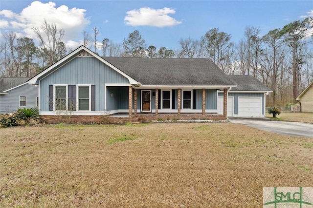 single story home featuring a garage, a front lawn, and covered porch