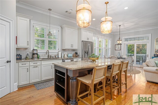 kitchen with white cabinetry, a center island, and stainless steel fridge with ice dispenser