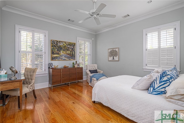 bedroom featuring crown molding, ceiling fan, and light wood-type flooring