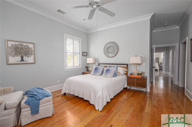 bedroom featuring hardwood / wood-style floors, ornamental molding, and ceiling fan