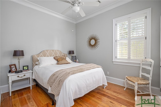 bedroom featuring multiple windows, hardwood / wood-style floors, and ornamental molding