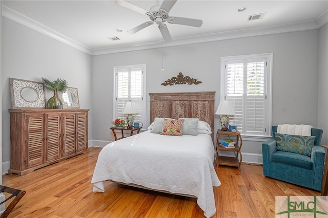 bedroom featuring ornamental molding, light hardwood / wood-style floors, and ceiling fan