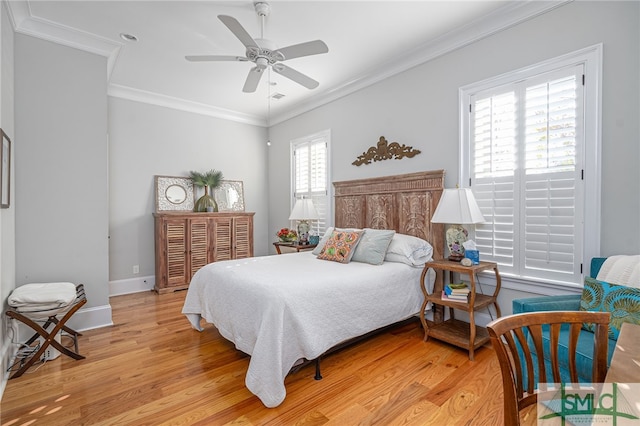 bedroom featuring light hardwood / wood-style flooring, ornamental molding, and ceiling fan