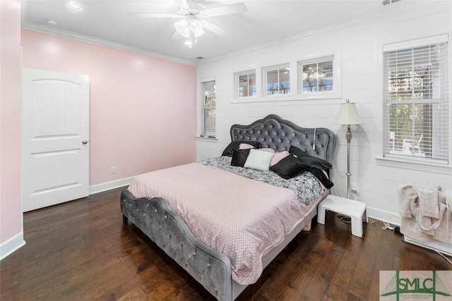 bedroom with crown molding, dark hardwood / wood-style floors, and ceiling fan