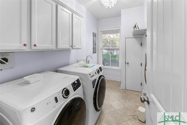 clothes washing area with cabinets, a chandelier, light tile patterned floors, and independent washer and dryer