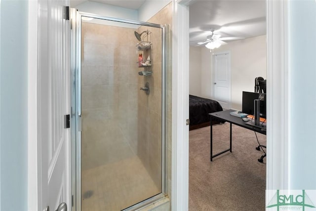 bathroom with a shower with door and ceiling fan