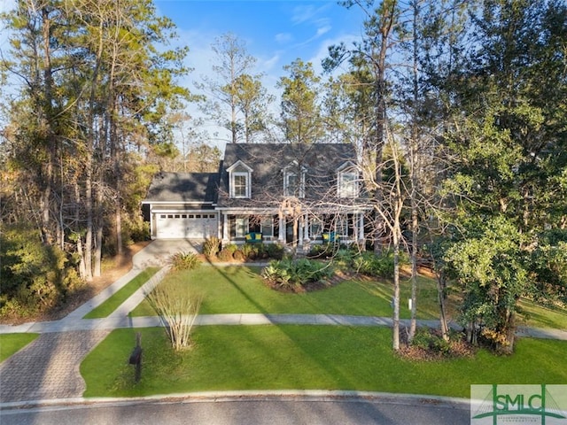 cape cod house with a garage and a front lawn