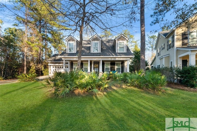 new england style home featuring a garage and a front lawn