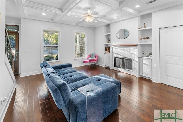 living room with dark hardwood / wood-style flooring, beam ceiling, and coffered ceiling