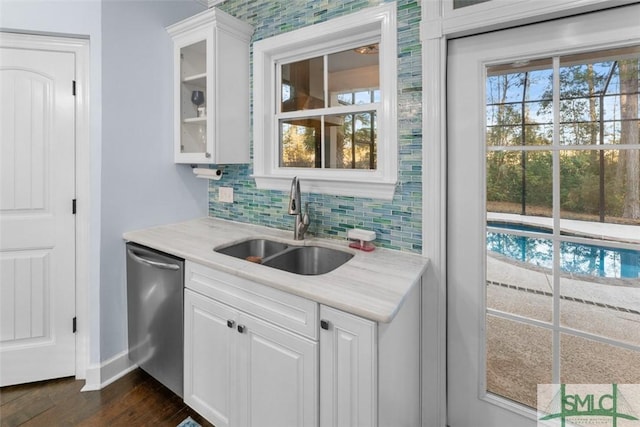 kitchen featuring tasteful backsplash, dishwasher, sink, white cabinets, and dark hardwood / wood-style flooring