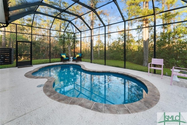 view of pool with a lanai and a patio area