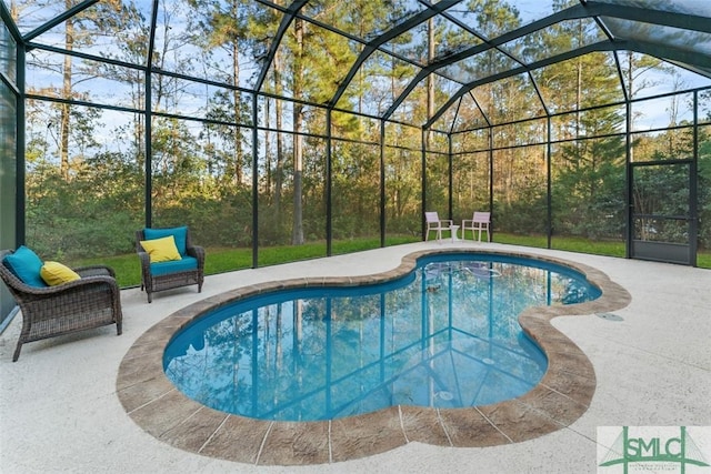 view of swimming pool featuring a lanai and a patio