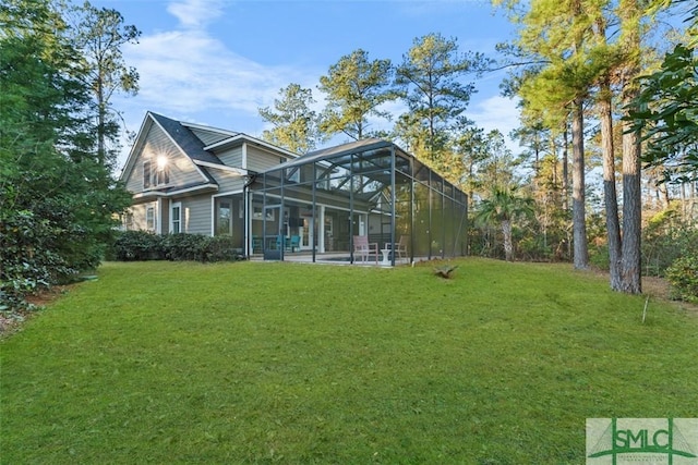 back of property featuring a yard and glass enclosure