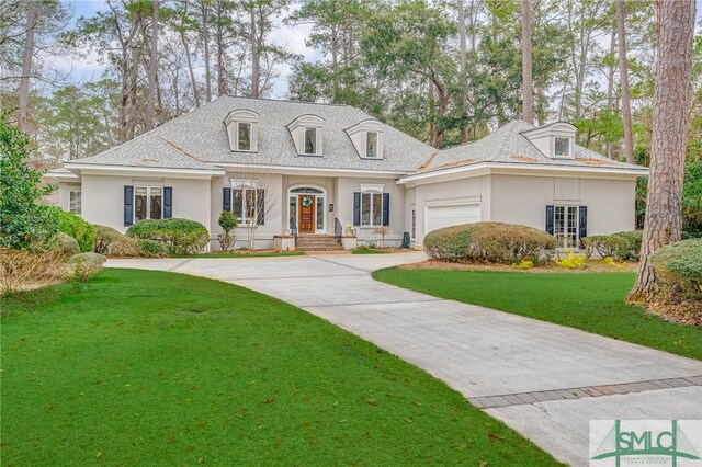 view of front facade with a garage and a front yard