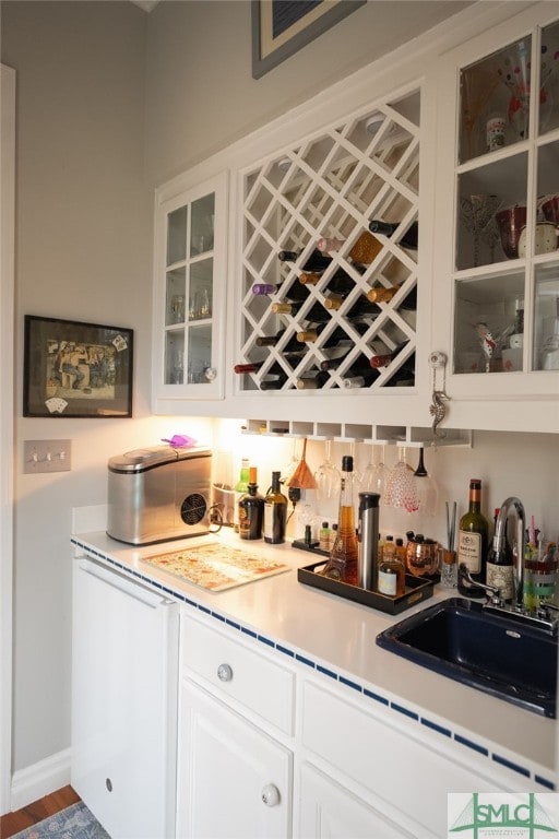 bar featuring sink and white cabinets