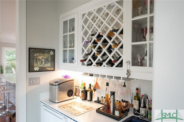 bar featuring sink and white cabinets