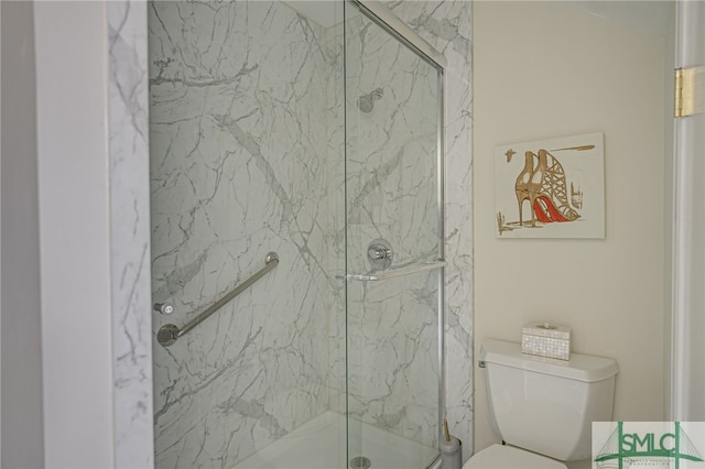 bathroom with an enclosed shower and toilet