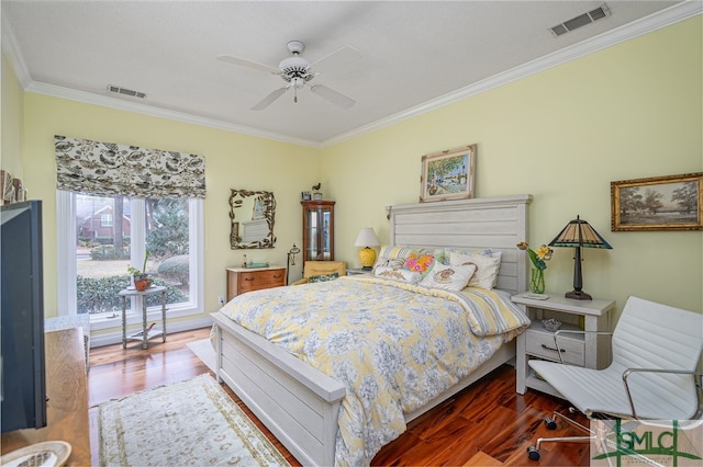 bedroom featuring dark hardwood / wood-style flooring, crown molding, and ceiling fan