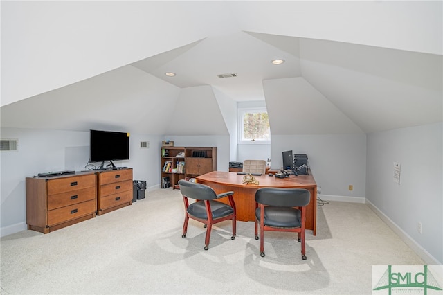 carpeted office space featuring vaulted ceiling