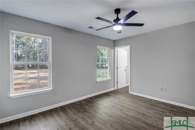 spare room with dark hardwood / wood-style floors and ceiling fan