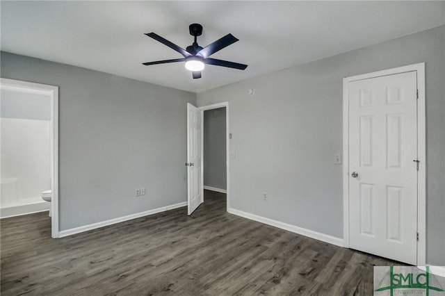 unfurnished bedroom with dark hardwood / wood-style flooring, ensuite bath, and ceiling fan